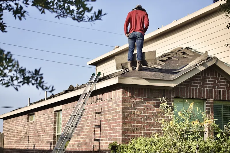 Professional roofer working on a residential roof in Wallace Meadows